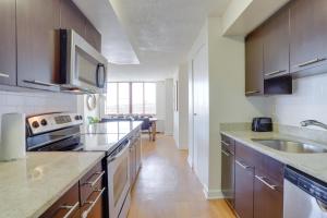 a kitchen with a sink and a counter top at Gorgeous Apt with Rooftop City View @Pentagon City in Arlington