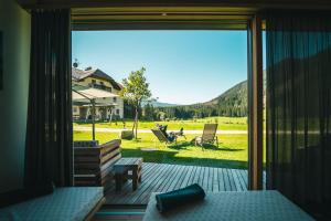 a bedroom with a sliding glass door with a view of a yard at Stacherhof in Planca di Sopra