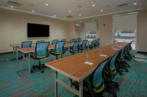 a conference room with tables and chairs and a flat screen tv at Home2 Suites By Hilton Grove City Columbus in Grove City