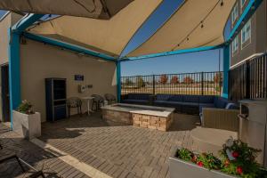 a patio with a couch and a table at Tru By Hilton The Colony in The Colony