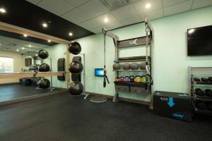 a room with a gym with a weight room at Tru By Hilton The Colony in The Colony