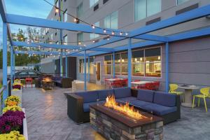 a patio with a fire pit in front of a building at Tru By Hilton Sandusky, Oh in Sandusky