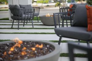 a group of chairs sitting around a fire pit at The Rewind West Des Moines, Tapestry Collection By Hilton in West Des Moines