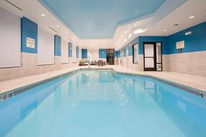 a swimming pool in a building with blue walls at Hampton Inn & Suites Watsonville in Watsonville