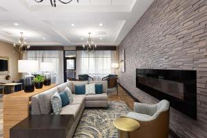 a living room with a couch and a fireplace at DoubleTree by Hilton Charleston Mount Pleasant in Charleston