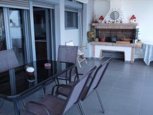 a dining room with a table and chairs and a fireplace at NINEMIA in Amfilochía