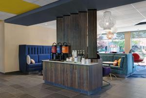 a lobby with a counter with bottles of wine at Tru By Hilton Tukwila Seattle Airport, Wa in Tukwila