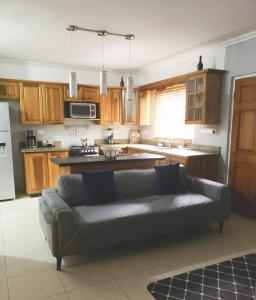 a living room with a couch in a kitchen at Comfortable & Secure Chateau in Kingston