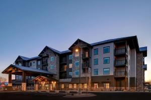 a rendering of the apartment building at dusk at Homewood Suites By Hilton Eagle Boise, Id in Eagle