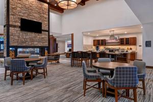 a lobby with tables and chairs and a fireplace at Homewood Suites By Hilton Eagle Boise, Id in Eagle
