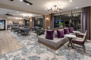 a lobby with a couch and tables and chairs at Homewood Suites By Hilton Albuquerque Downtown in Albuquerque