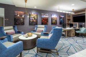 an office with blue chairs and a desk with a computer at Homewood Suites By Hilton Albuquerque Downtown in Albuquerque