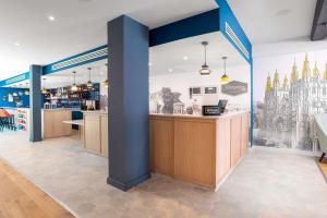 a view of a restaurant with a counter in a room at Hampton by Hilton Canterbury in Canterbury