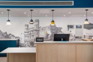 an office with a wall mural of a building at Hampton by Hilton Canterbury in Canterbury