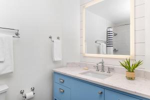 a bathroom with a blue sink and a mirror at Hyatt Vacation Club at Beach House in Key West +3 photos