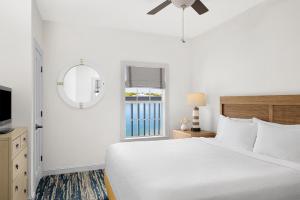 a white bedroom with a bed and a window at Hyatt Vacation Club at Beach House in Key West +19 photos