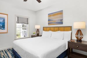 a bedroom with a large white bed and two windows at Hyatt Vacation Club at Beach House in Key West