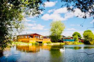 a house on the side of a river with a building at 3 bedroom Heaven Home in Chichester