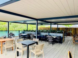 a patio with tables and chairs and a bar at 3 bedroom Heaven Home in Chichester