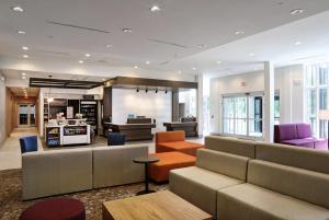 a lobby with couches and tables in a building at Hilton Garden Inn Bel Air, Md in Bel Air