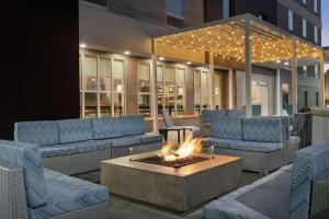 a patio with couches and a fire pit in front of a building at Home2 Suites By Hilton Vicksburg, Ms in Vicksburg