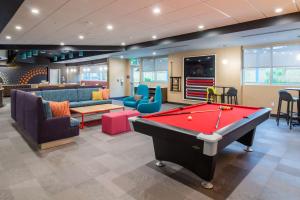 a billiard room with a pool table and chairs at Tru By Hilton Niceville, Fl in Niceville