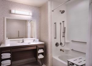 图珀洛Home2 Suites By Hilton Tupelo的带水槽、浴缸和镜子的浴室