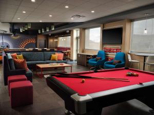 a billiard room with a pool table and chairs at Tru By Hilton Tupelo, Ms in Tupelo