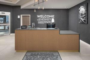 a lobby with a reception desk with a welcome sign on the wall at Hampton Inn & Suites Huntsville Downtown, Al in Huntsville