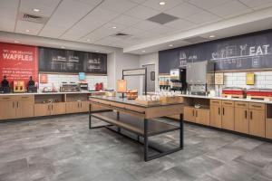 a large kitchen with a counter in a restaurant at Hampton Inn & Suites Huntsville Downtown, Al in Huntsville