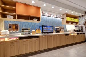 a kitchen with wooden cabinets and a counter top at Home2 Suites By Hilton Las Vegas Northwest in Las Vegas