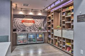 a grocery store aisle with a treatsmite sign on the wall at Hampton Inn & Suites Keene in Keene