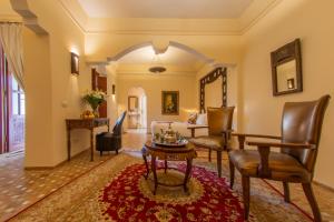 a living room with a couch and a table at Demeures d'Orient Riad & Spa in Marrakesh