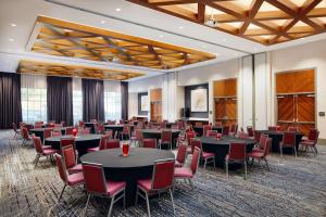 a conference room with tables and chairs and a podium at Embassy Suites By Hilton Atlanta Airport North in Atlanta +40 photos