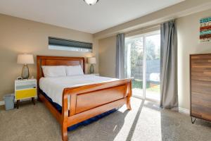 a bedroom with a bed and a large window at Accommodating Anchorage Abode Less Than 1 Mi to Jewel Lake in Anchorage