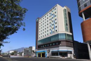 un edificio alto en la esquina de una calle en Tru By Hilton Monterrey Fundidora, en Monterrey