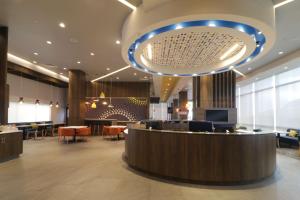 a lobby of a hotel with a bar and chairs at Tru By Hilton Monterrey Fundidora in Monterrey