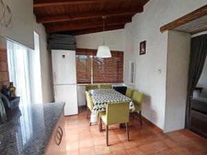 a kitchen and dining room with a table and chairs at A Casa da Bicicleta in Lousã
