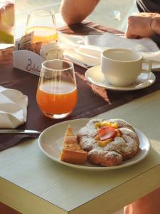 a table with a plate of food and a glass of orange juice at Yes Hotel Touring & SPA in Rimini
