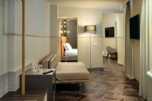 a small hotel room with a bed and a bedroom at Cosmopolita Hotel Rome, Tapestry Collection by Hilton in Rome