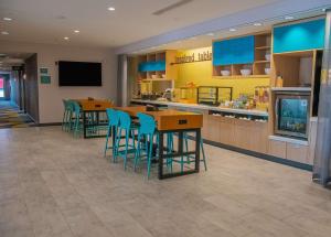 a restaurant with chairs and tables and a counter at Home2 Suites By Hilton Logansport in Logansport