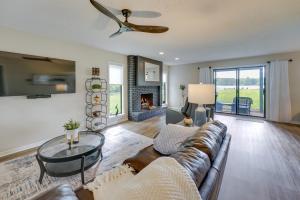 a living room with a couch and a fireplace at Lakefront Michigan Rental with Kayak and Fire Pit 