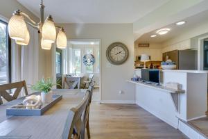 a kitchen and dining room with a long table and a clock at Lakefront Michigan Rental with Kayak and Fire Pit 