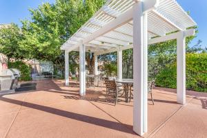 a white pergola on a patio with a table and chairs at Hilton Vacation Club Ridge on Sedona in Sedona