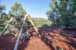 a wooden swing in a field with trees at Hilton Vacation Club Ridge on Sedona in Sedona
