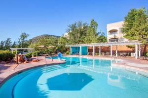 a swimming pool at a resort with blue water at Hilton Vacation Club Ridge on Sedona in Sedona