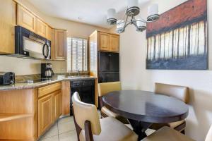 a small kitchen with a table and chairs in a room at Hilton Vacation Club Ridge on Sedona in Sedona