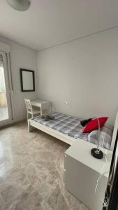 a bedroom with a bed and a desk and a chair at Preciosa a 2 min Renfe in Gandía