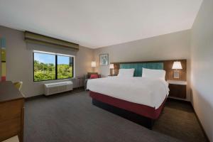 a hotel room with a large bed and a window at Hampton Inn by Hilton Detroit Southfield in Southfield +34 photos