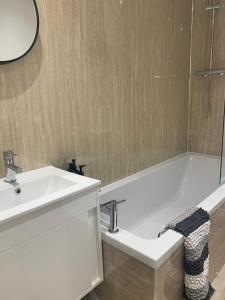 a bathroom with a sink and a bath tub at The Victorian Apartment in Dundee +15 photos